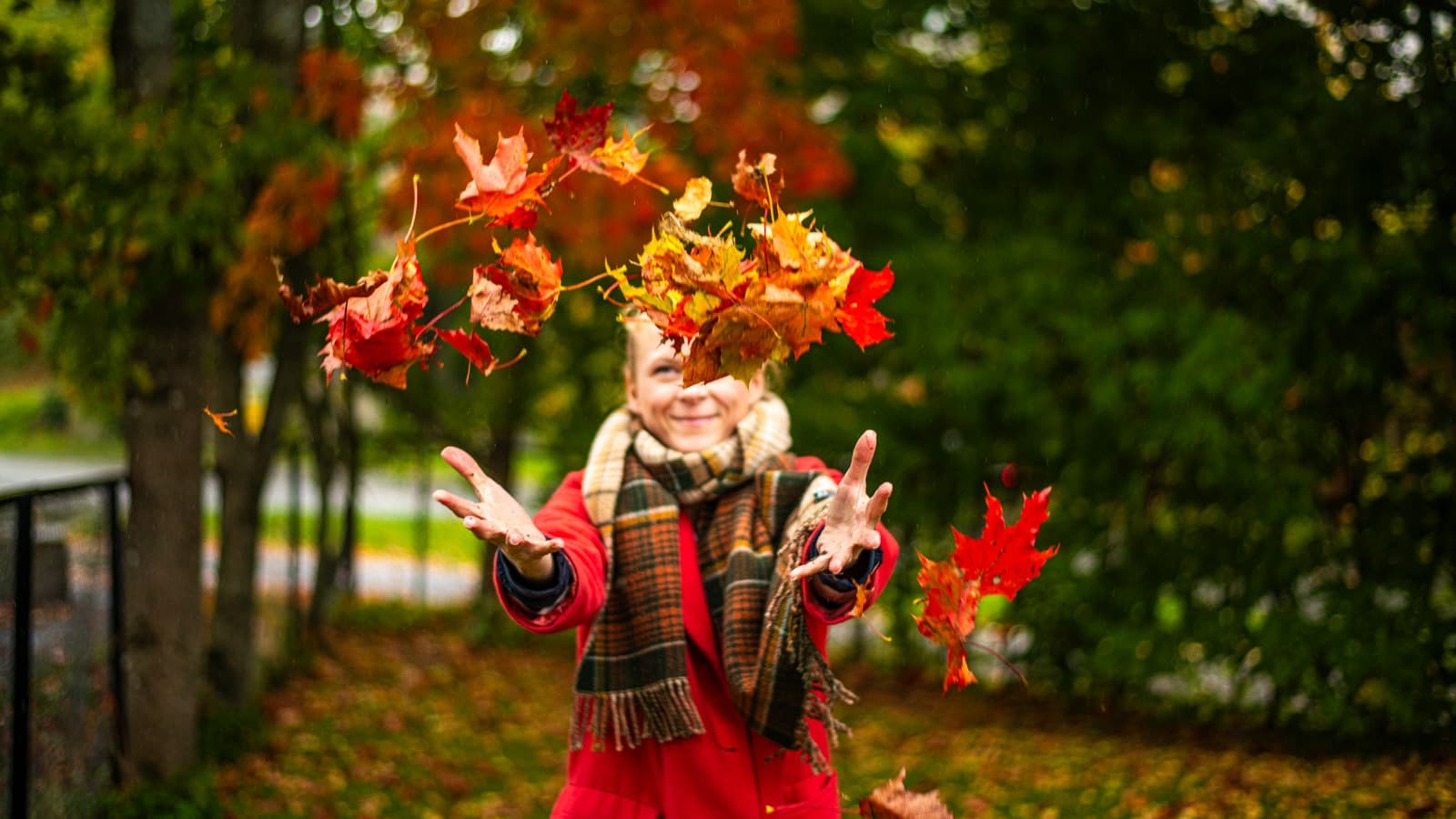 Dame som kaster høstløv